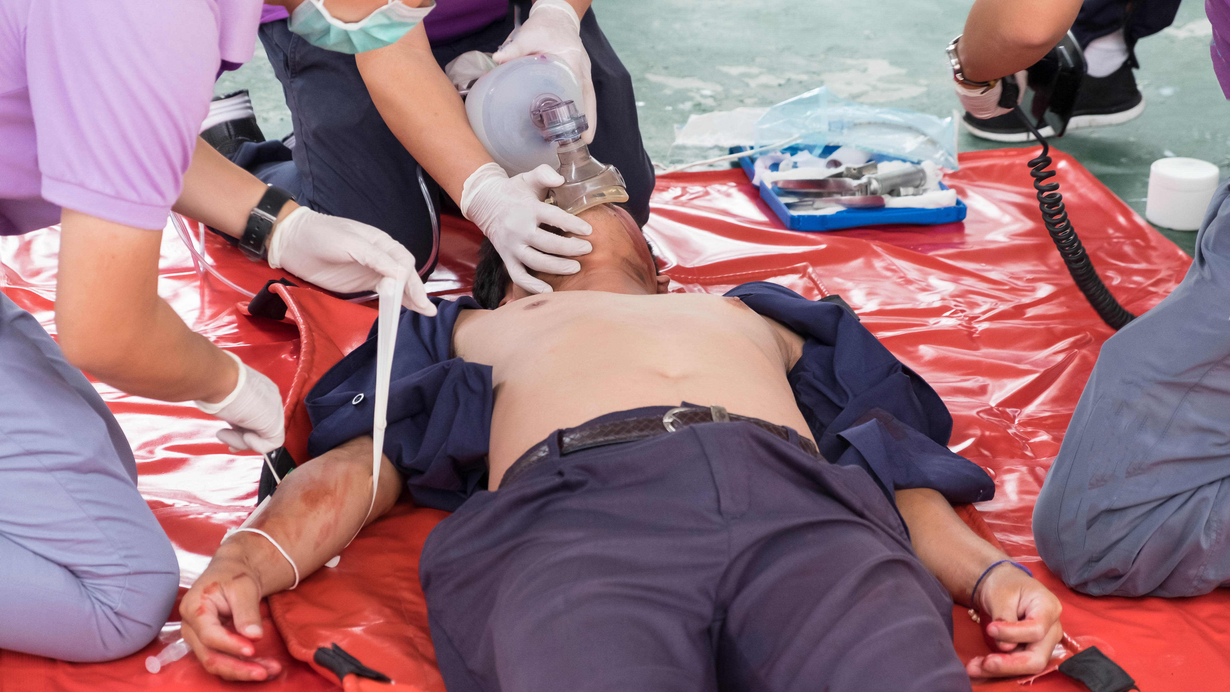 EMT Team Working students practicing saving victim in emt school